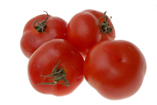 Four ripe tomatoes isolated on white background.
