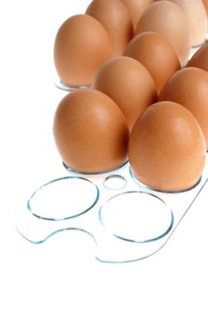 Brown eggs on a acrylic transparent stand isolated on white background.