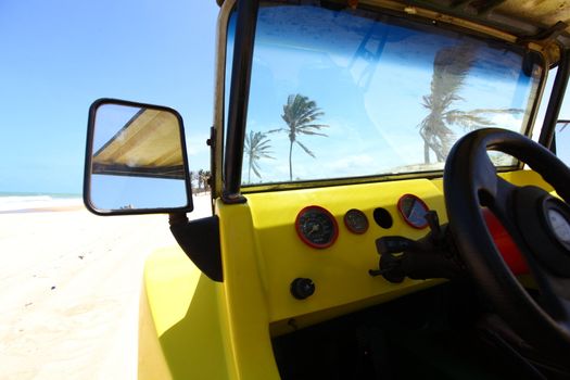 desert buggy in desert sand under blue sky