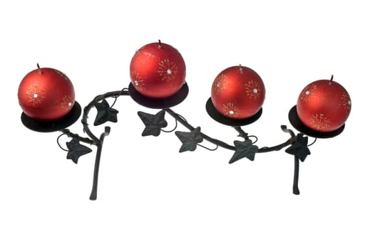 Christmas decoration with red wax candles on a white background.