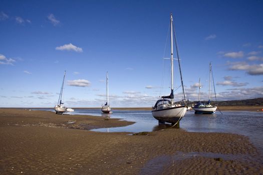 Yachts at anchor in Red Wharf Bay, Anglesey at low tide