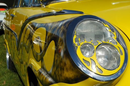 custom headlight on a colorful hot rod