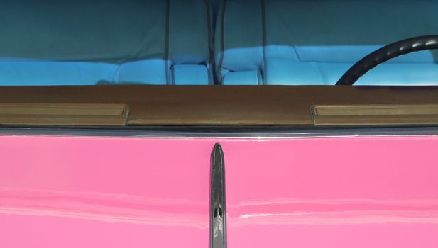 pink 1950's classic car with tinted windows