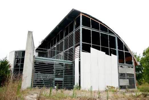 Abandoned modern building with broken windows.