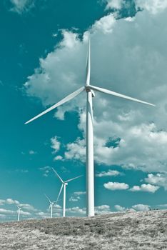Beautiful meadow with Wind turbines generating electricity.