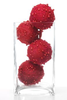 Christmas decorative balls in glass jar isolated on white background.