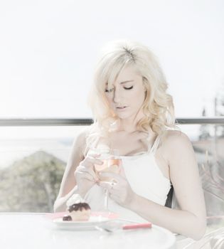 high key image of woman having wine and dessert