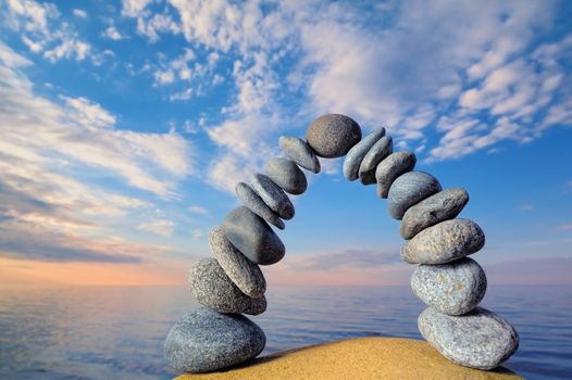 Arc of the pebbles on the sea coast