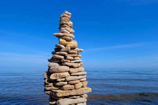 Pile of pebble as the tower on the sea coast