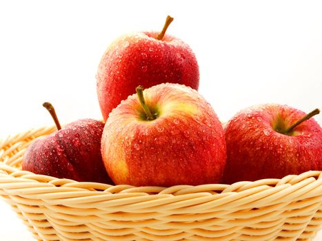 Red apples in basket towards white background