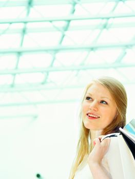 Happy young female holding shopping bag