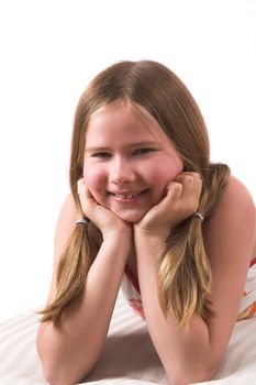 Pretty ten year old girl leaning on her hands while lying on the couch