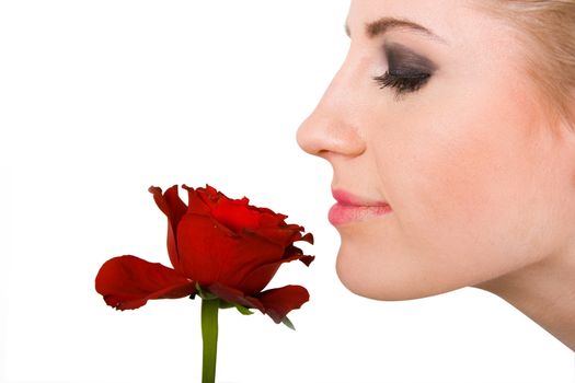 Close-up of young woman smelling red rose