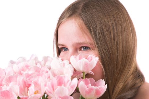 Pretty ten year old girl smelling the bouquet of pink tulips