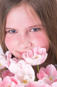 Beautiful young girl with pink tulips for mother on mother's day