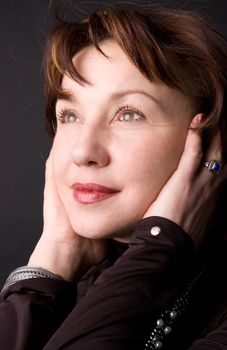 Portrait of the woman in studio on a black background.