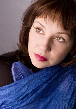 Portrait of the woman in studio on a grey background.