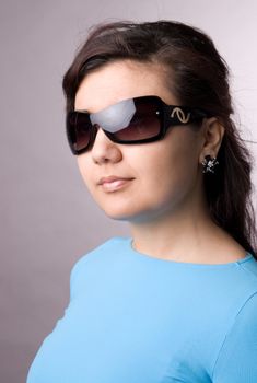 Multi-ethnic girl in studio on grey background.