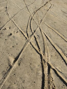 earth or sand background with tire tracks