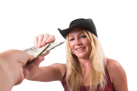 Pretty blond woman reaching for a stack of dollars