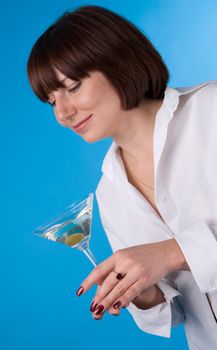 The woman in a white shirt with a glass of martini
