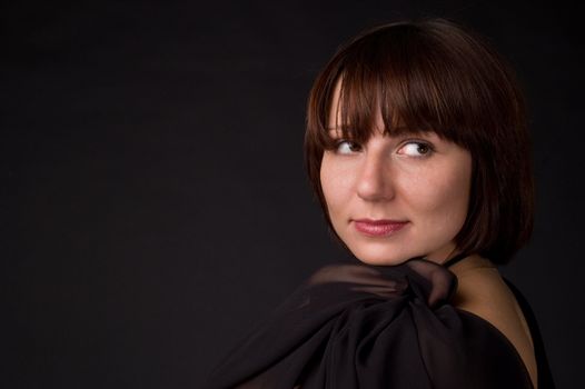 The woman in a dress on a black background