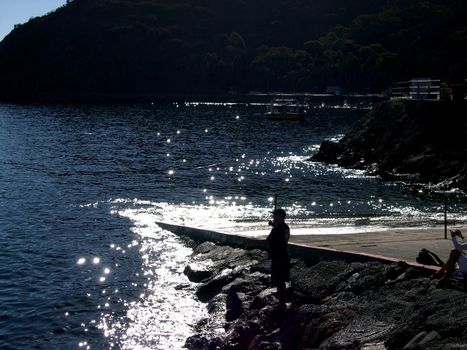 A person fly fishing in the ocean