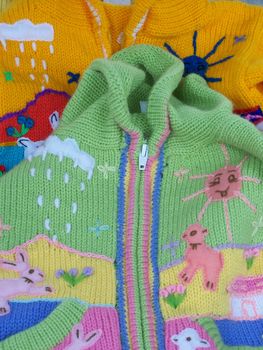 colorful baby sweaters look like spring and Easter