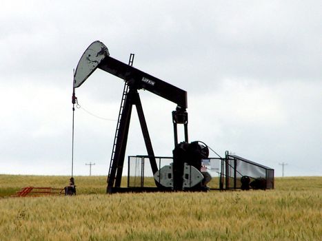 this oil jack is pumping oil out of an oil field in the praries