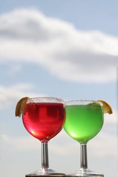 Two glasses with a cocktail at a window