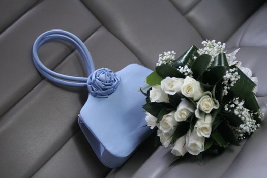 Bride bouquet and a small  blue  bag