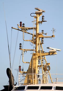 Mast of a tug boat in Hamburg harbour, Germany. Lots of maritime navigational technology: radar, aerial, searchlight, signals...