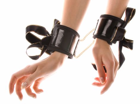 Leather handcuffs with golden chains on isolated background
