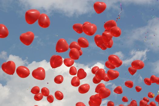 Red-coloured balloons on a background of the blue sky