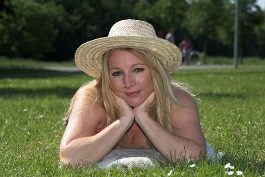 beautiful blond woman relaxing in the park