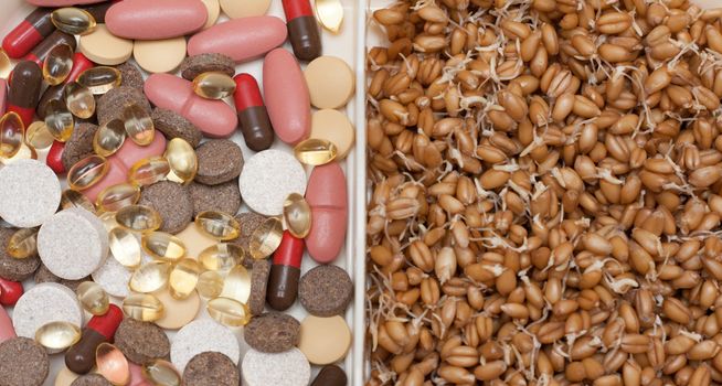 Container with pill, tablet and wheat on white background