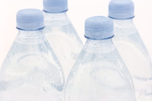 Cool and refreshing. Close up of water bottles.