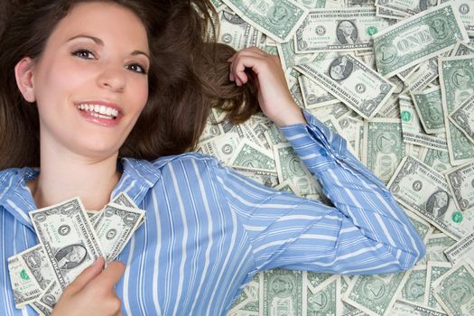 Beautiful woman laying in money