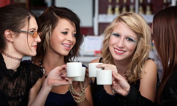 Young Sexy teen friends having Coffee in a Restaurant