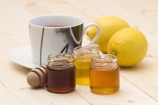 cup of tea, honey and fresh lemons