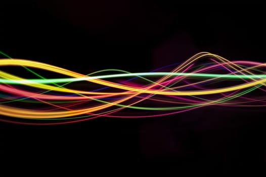 abstract sinusoidal waves of light on a black background
