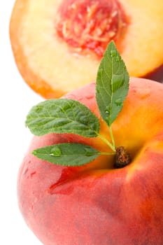 close-up ripe peach with leaves, isolated on white