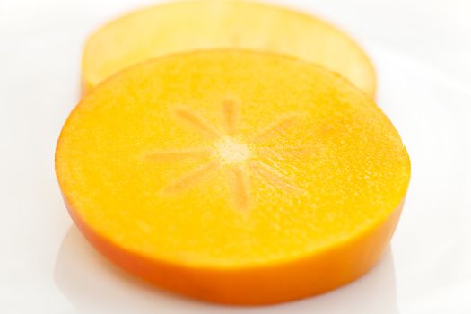 Persimmon slice on white background with clipping path.