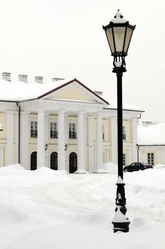 Oginski Palace in Siedlce, Poland covered with snow in winter with street light in the foreground