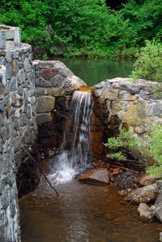 Picture of a natural small water fall in summer