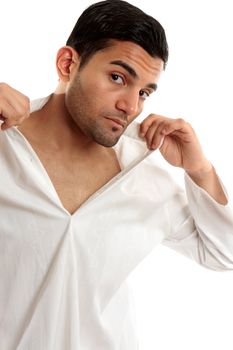 Handsome man putting on or taking off clothing.  White background.