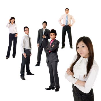 Young business woman and her team over white background, focus on woman in front.