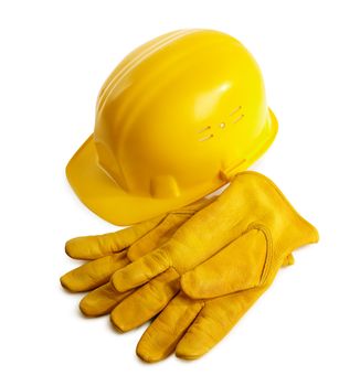 yellow hardhat and working gloves isolated on white background, selective focus
