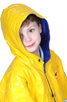 Four year old boy with big blue eyes in a yellow rain coat against a white  background. Shot with the Canon 20D.