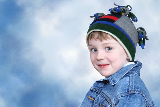 Four year old boy in crazy looking winter cap and a denim jacket.  Shot with the Canon 20D.